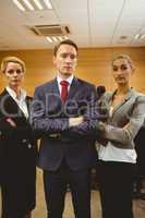 Three unsmiling lawyers looking at camera crossed arms