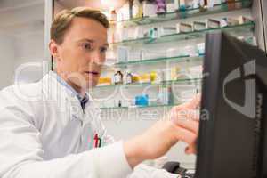 Focused pharmacist using the computer