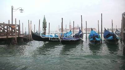 Gondolas in Venice at the pier and view San Giorgio Maggiore island