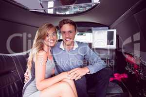 Happy couple smiling in limousine