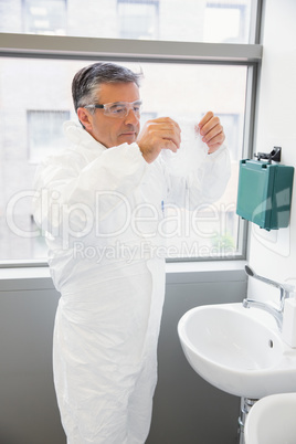 Pharmacist washing his hands at sink