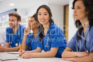 Medical student smiling at the camera during class