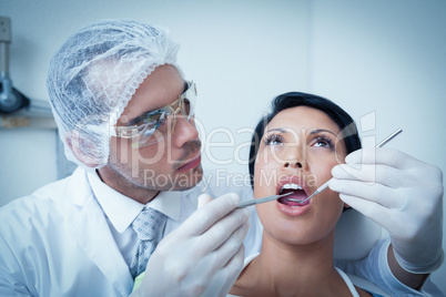 Male dentist examining womans teeth