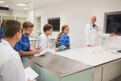 Medical professor teaching young students