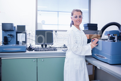 Young chemist with safety glasses doing scientific research