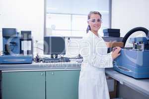 Young chemist with safety glasses doing scientific research