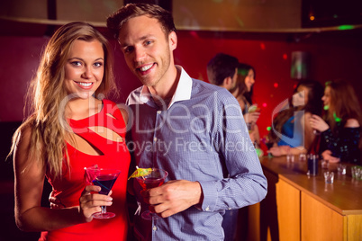 Cute couple drinking cocktails together