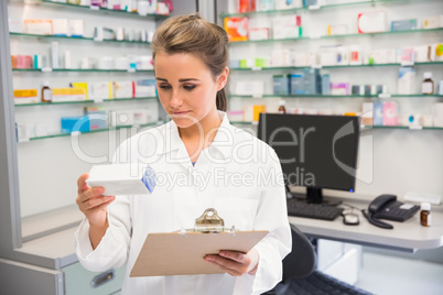 Junior pharmacist holding medicine box