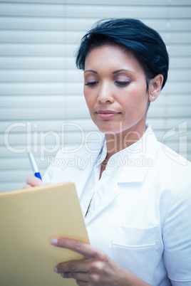 Female dentist reading reports