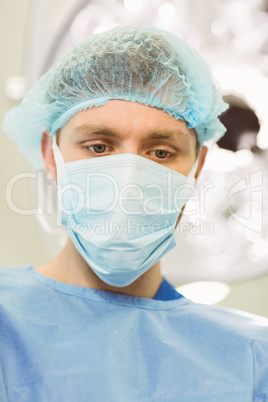 Young surgeon wearing mask and cap