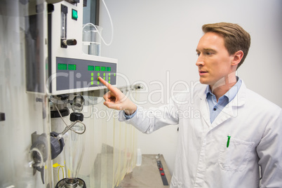 Pharmacist using machinery to make medicine