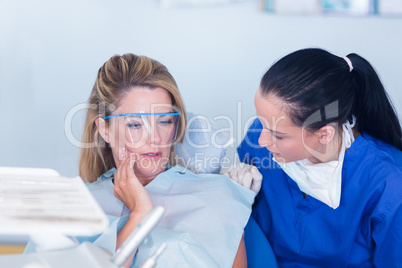 Dentist speaking with patient about toothache