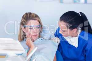 Dentist speaking with patient about toothache