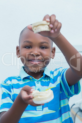 Portrait of boy holding mouth model