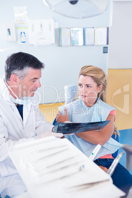 Dentist discussing x-ray with his patient