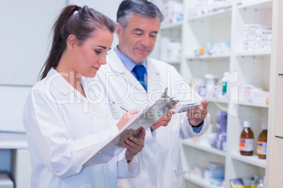 Pharmacist looking a medication for a prescription