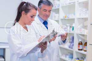 Pharmacist looking a medication for a prescription