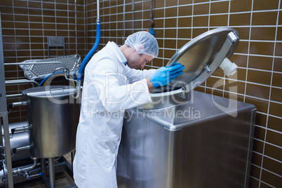 Man in lab coat looking into the machine