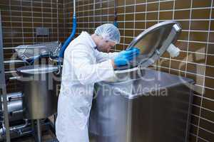 Man in lab coat looking into the machine