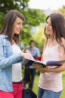 Pretty students reading from notepad