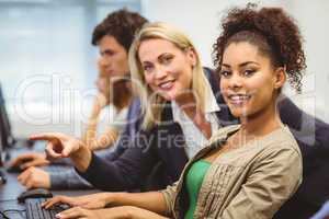 Cheerful teacher and student looking at camera