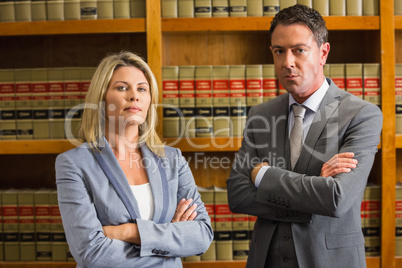Lawyers looking at camera in the law library