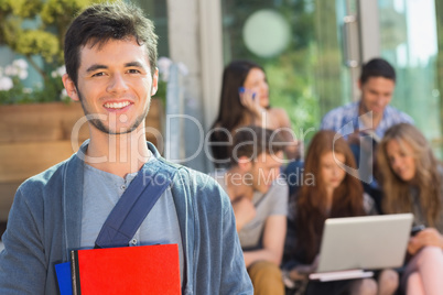 Happy student smiling at camera outside on campus