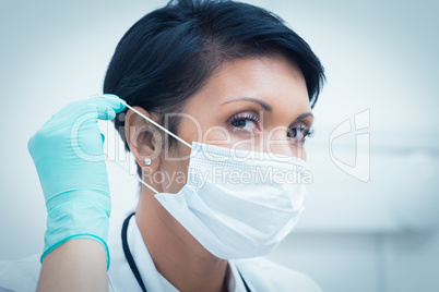 Female dentist wearing surgical mask