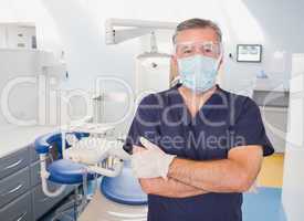 Portrait of a dentist with arms crossed and surgical mask
