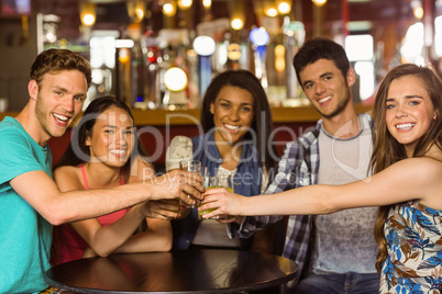 Portrait of happy friends toasting with drink and beer