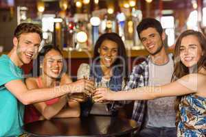 Portrait of happy friends toasting with drink and beer