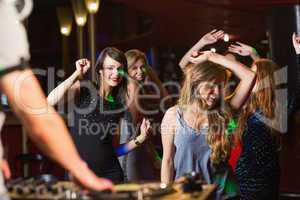 Happy friends dancing by the dj booth