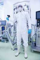 Scientist in protective suit holding ladder