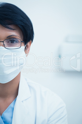 Female dentist wearing surgical mask