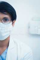 Female dentist wearing surgical mask