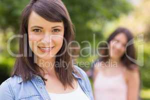 Pretty student smiling at camera outside on campus