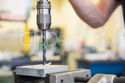 Engineering student using large drill