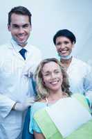 Portrait of dentist with assistant and female patient