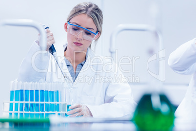 Science student using pipette in the lab