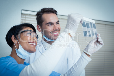 Dentists looking at x-ray