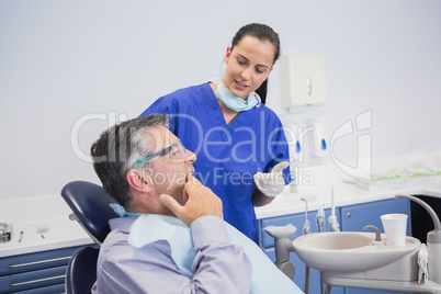 Dentist talking with her patient