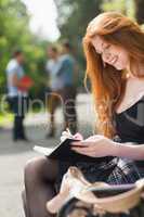 Pretty student studying outside on campus