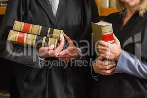 Lawyers holding books in the law library