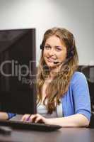 Student sitting at the computer room wearing headset