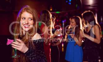 Pretty redhead drinking a cocktail