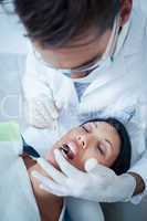 Male dentist examining womans teeth