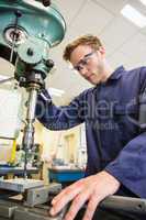 Engineering student using large drill