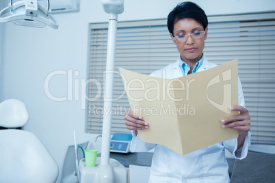 Dentist reading reports