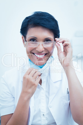 Confident female dentist smiling