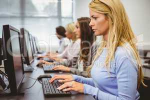 Four focused women working in computer room